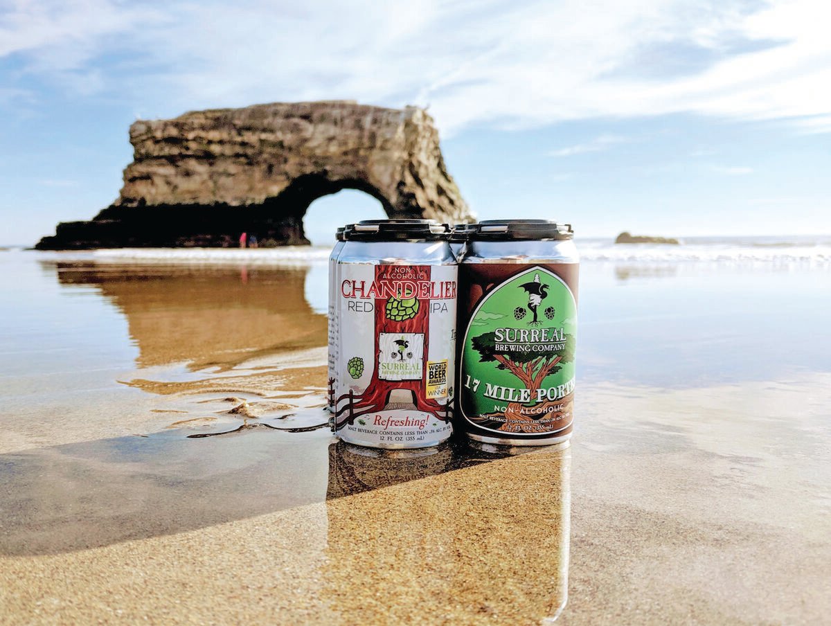 surreal brewing co. beer cans on the beach