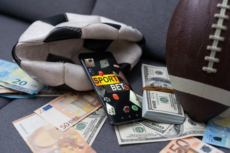 A cell phone and money on a couch