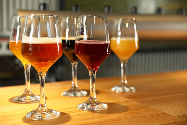 A diverse lineup of craft beers arranged on a bar, each representing a different bettor’s personality and style