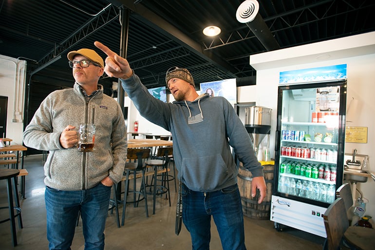Brian Sorensen visits with Eric-Hahn, owner, at Mad Rooster Beer Co. in Fayetteville Arkansas