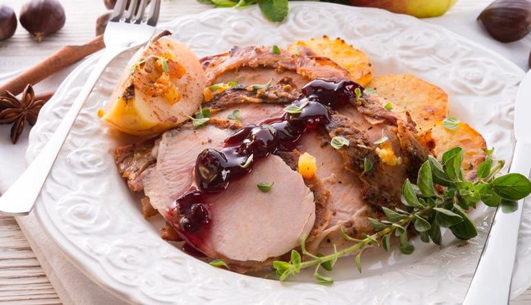 cranberry and orange glazed turkey breast on table for thanksgiving