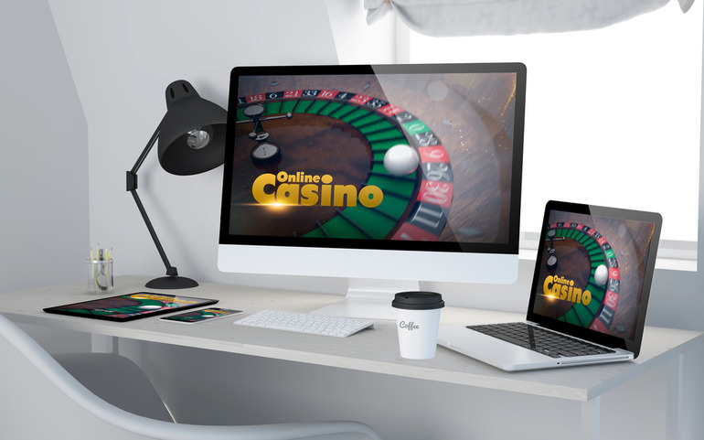 A PC and laptop displaying popular online casino
