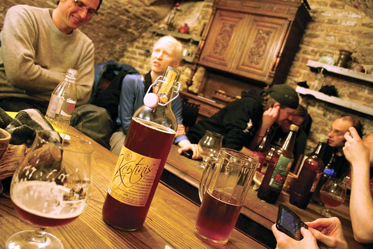 patrons enjoy farmhouse brews in plastic bottles over glass or aluminum
