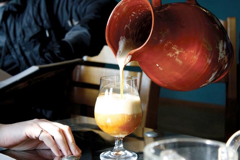 lithuanian beer pouring from a porcelain kettle