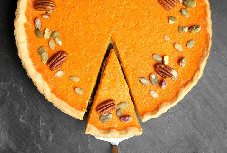 pumpkin pie with slice taken
