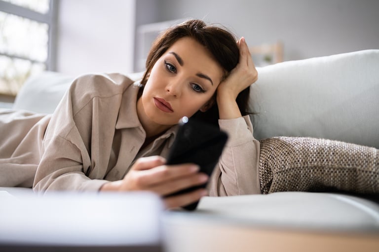 Woman using social media on phone with a bad mental condition