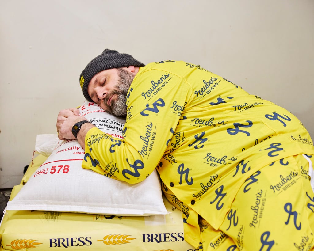 Reuben's Brews Pajama Jammy Jam promotional image of brewer sleeping on grain sack