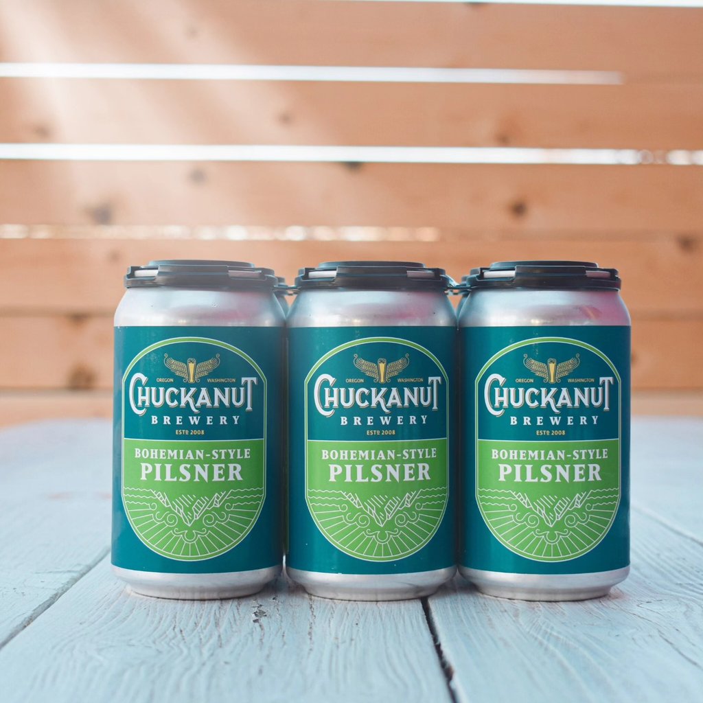 chuckanut pilsner six-pack on table with wood slats behind