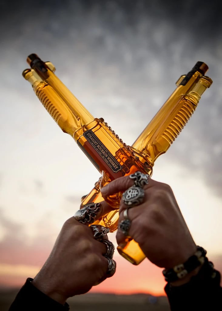 Machine Head Shotgun Blast Whiskey bottles crossed and pointed skyward
