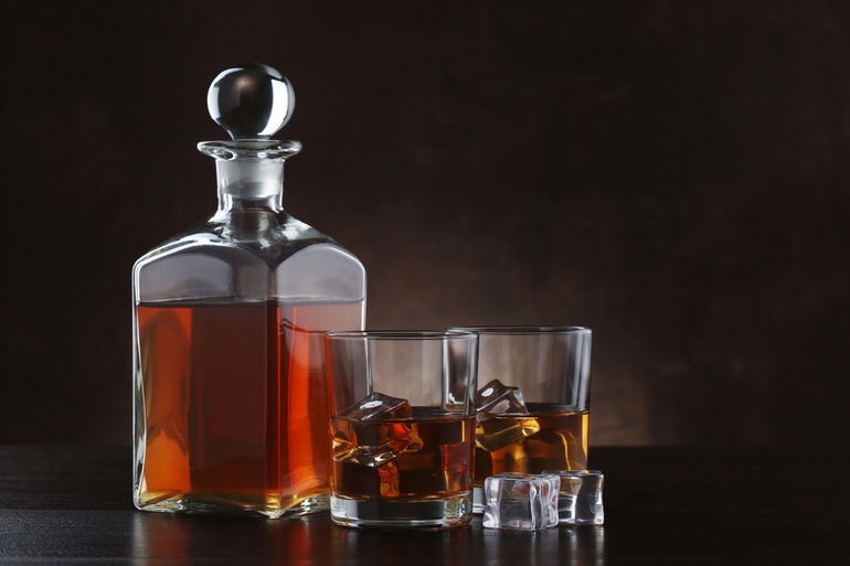 A Decanter and Two Glasses of Irish Whiskey on a Dark Background