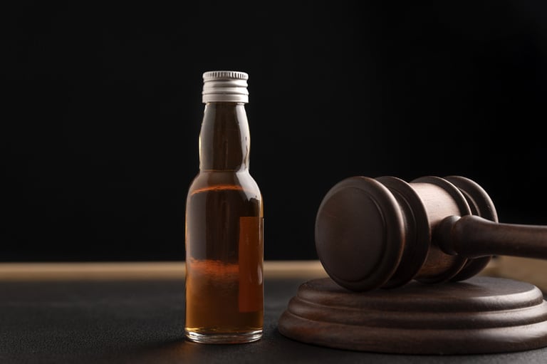 A bottle of beer beside a judge's gavel, symbolizing legal principles in emerging beer markets