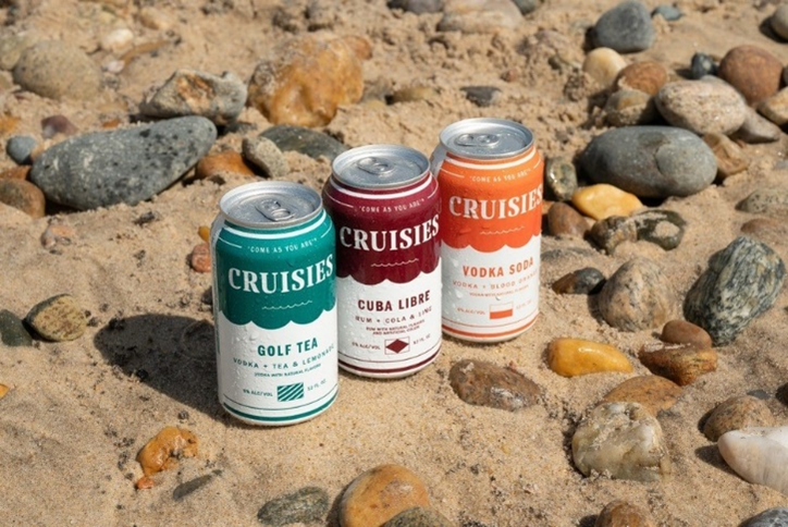 Tilray Cruisies RTD Canned Cocktails on a sandy, rocky beach