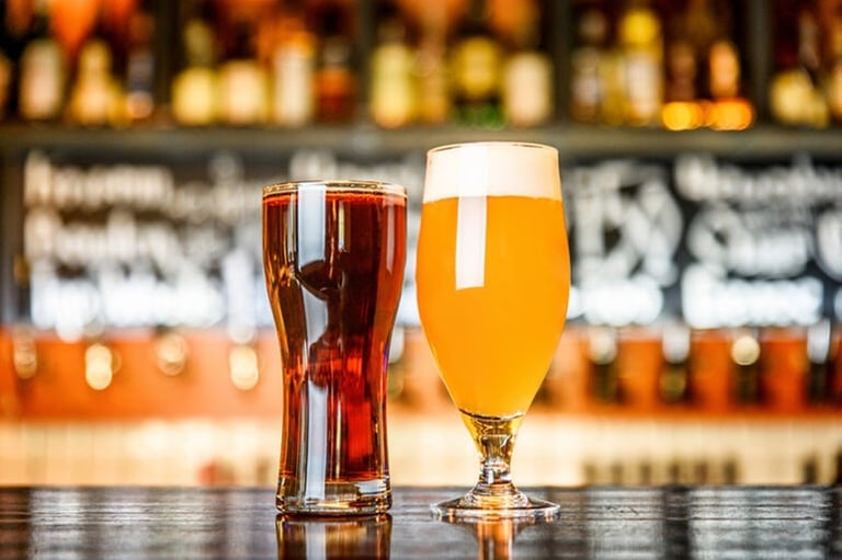 Glass of light and dark beer on a pub table, perfect for a weekend escape in New York