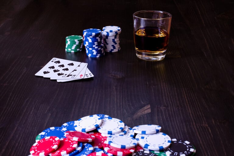 Beer glass with poker chips and playing cards on the table