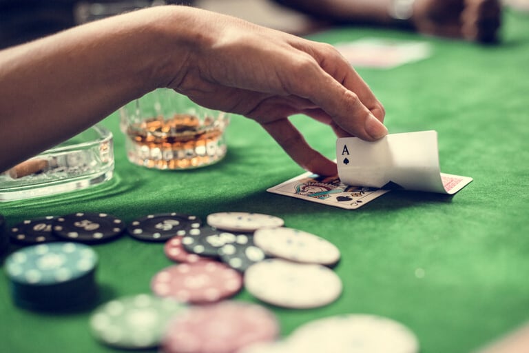 A man is enjoying casino games and beer at a game night