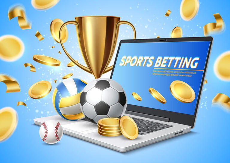 Baseball, football, basketball, and gold coins around a laptop displaying an online sports betting app