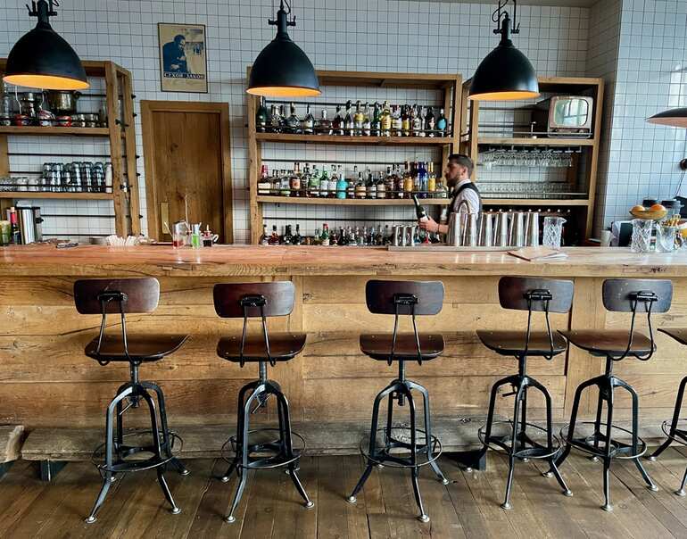Industrial-style restaurant chairs lined up at a rustic brewery taproom