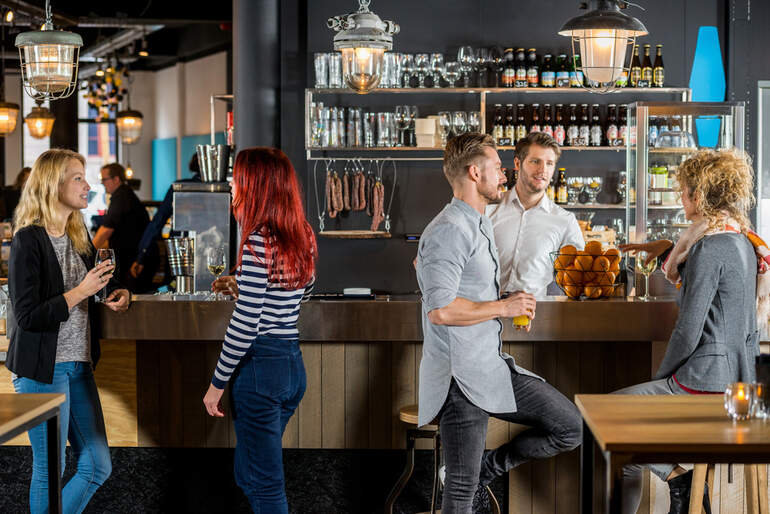 Young people socializing in a lively local pub in Tottenham