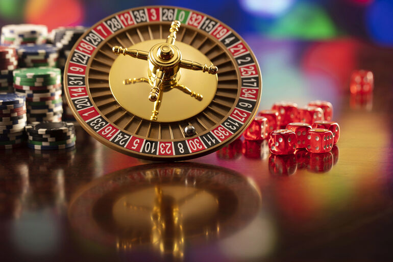 Roulette wheel, poker chips, and dice representing online sweepstakes casino trends in 2025.