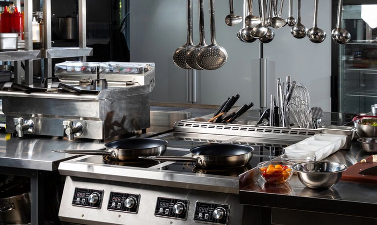Modern commercial kitchen setup with professional cooking equipment and an organized workspace