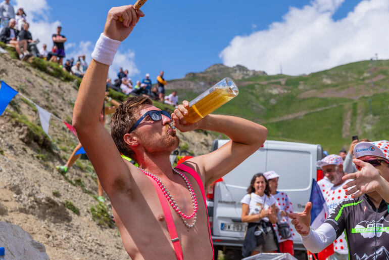 A cheering man drinks beer during a beercation trip