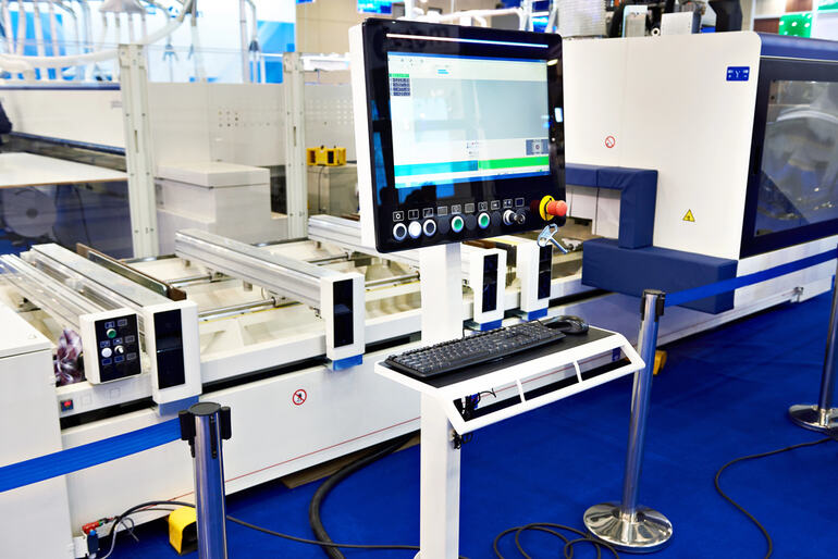 Advanced automated packaging quality control machine with digital interface in a modern production facility.
