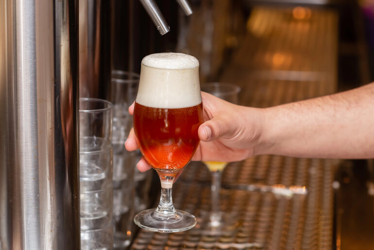 Raising a glass of craft beer while exploring the online casino boom, blending luck, gaming, and brewery culture