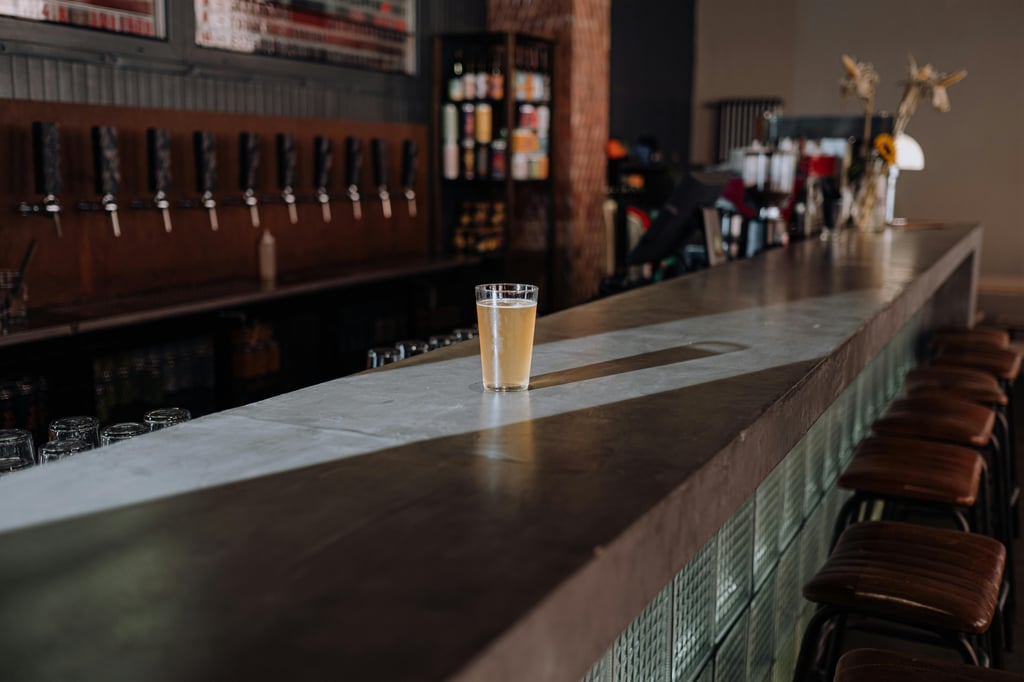 A single mug of beer set against may beer taps