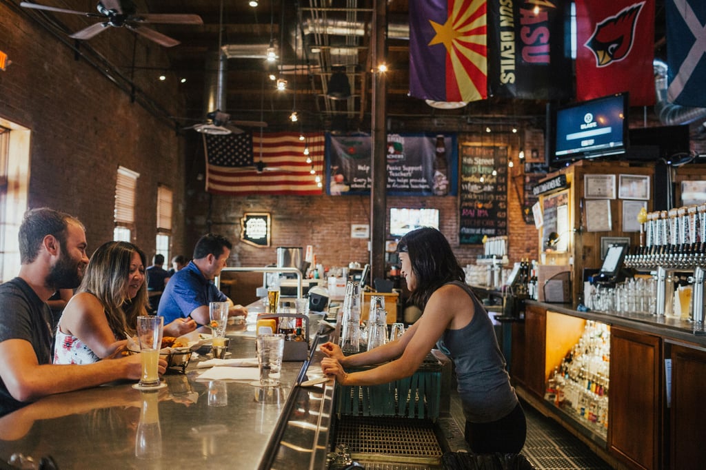 People Drinking With a U.S. Flag Overhead