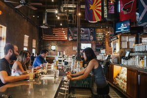 People Drinking With a U.S. Flag Overhead