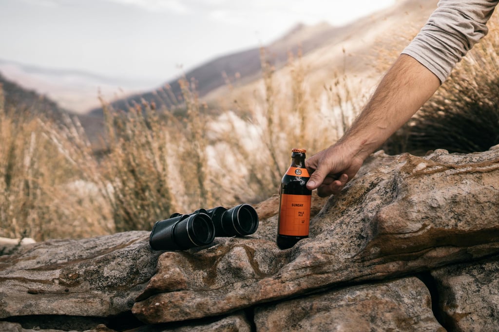 Beer and binoculars in a mountain setting
