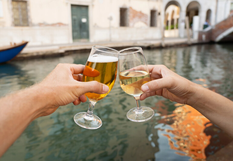 Clinking beer and champagne glasses as a beer lover explores champagne flavors