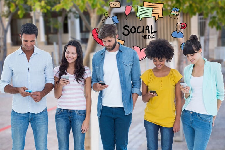 A diverse group of young adults walking outdoors while using smartphones