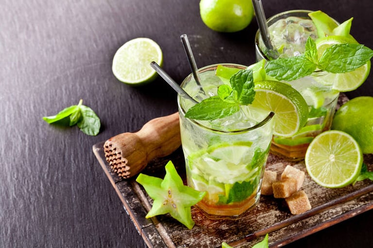 Fresh herbs garnish and a glass of mojito