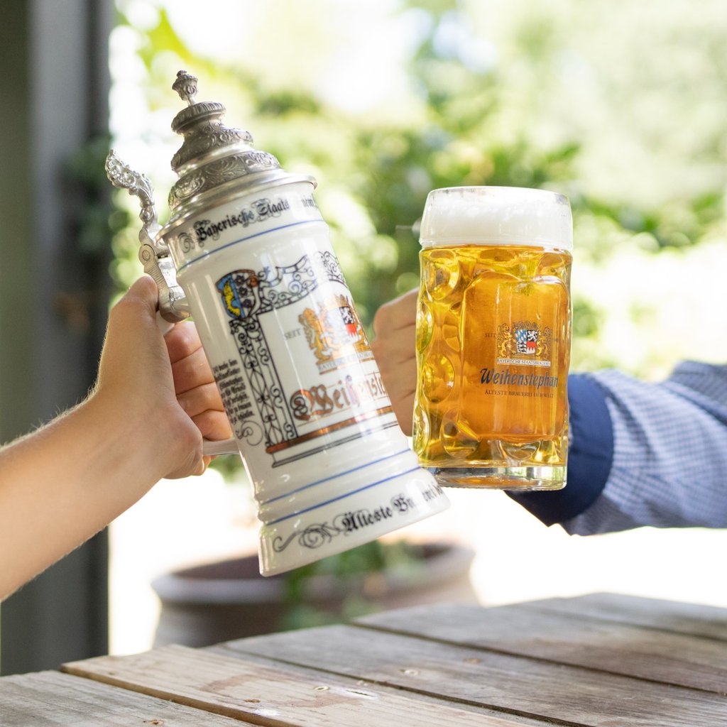 Stein and mug of golden Weihenstephaner beer
