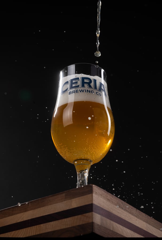 View of beer being poured into a Ceria tulip glass.