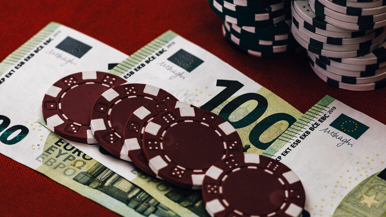 A stack of money and casino coins