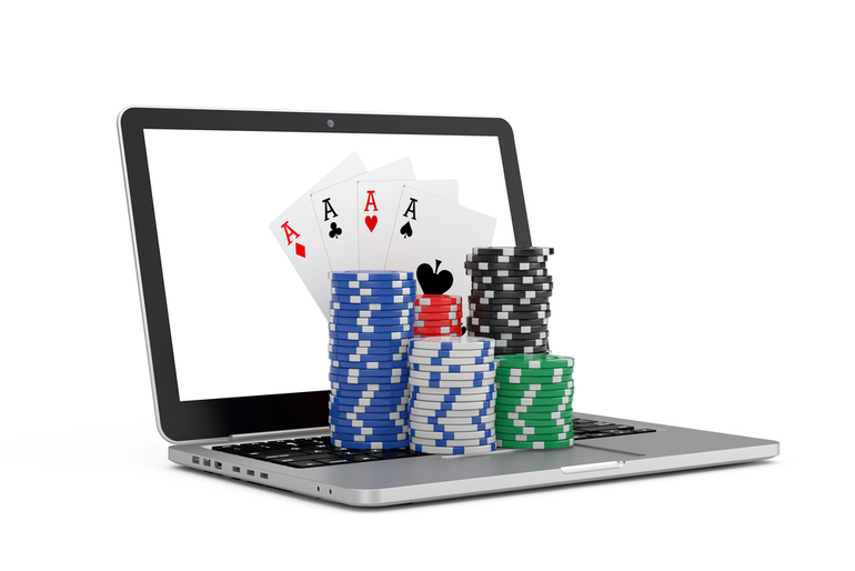 Online casino on laptop screen with playing cards and stacked poker chips, representing the Spinbetter Casino game library and online gaming experience
