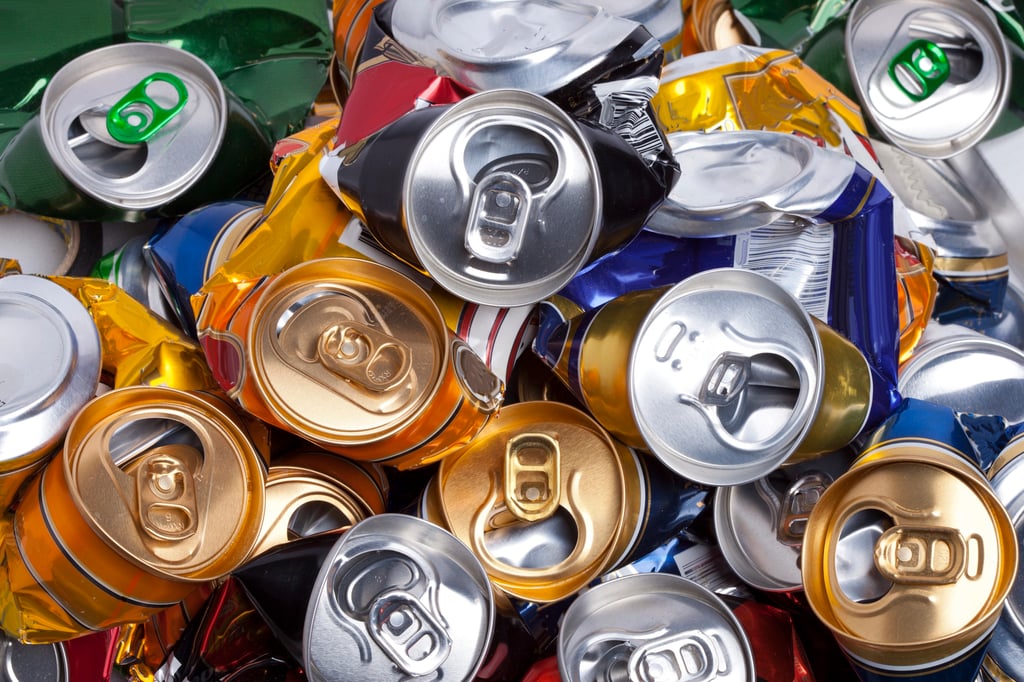 Collection of crushed beer cans on the ground.