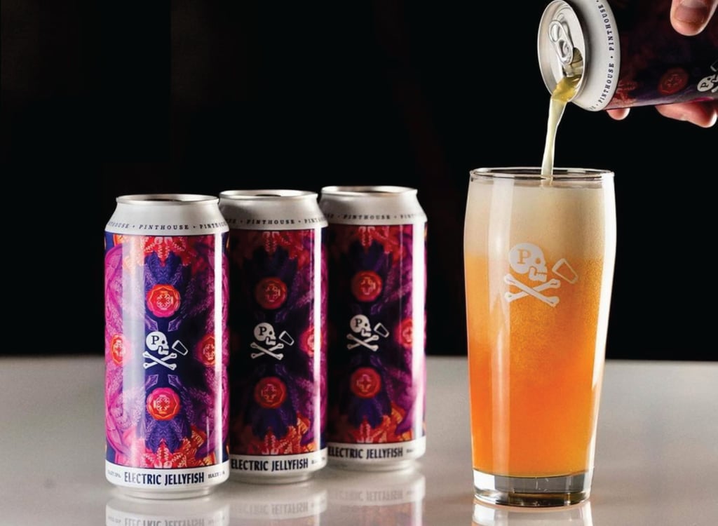 Electric Jellyfish IPA being poured from a can into branded glassware.