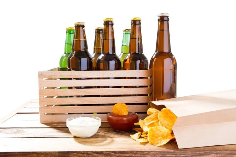 Beer bottles arranged with assorted food items on a table