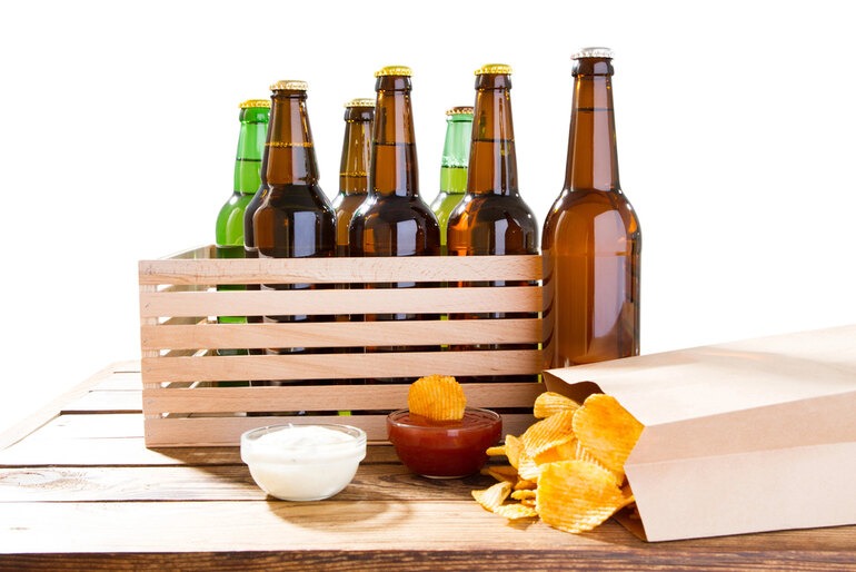 Beer bottles arranged with assorted food items on a table