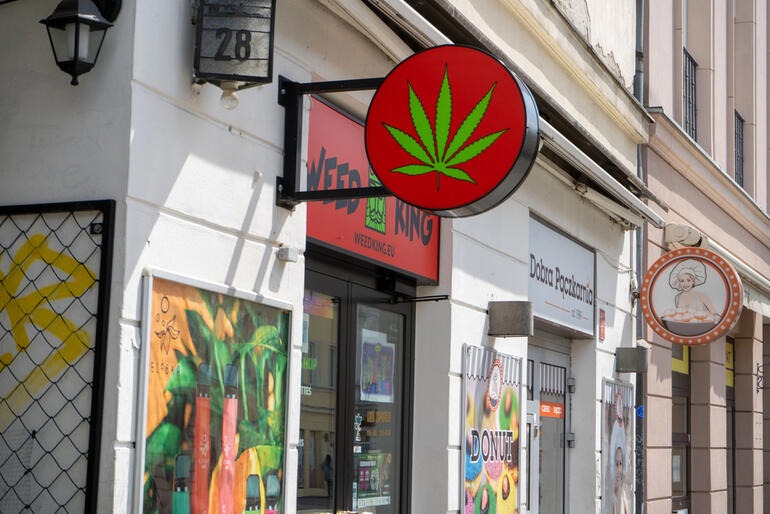 Cannabis store with a prominent marijuana leaf sign. 