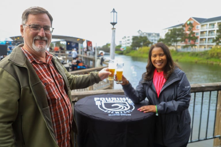Man and woman toasting beer glasses at Pouring at the Coast Brewfest: Seaside Orgegon