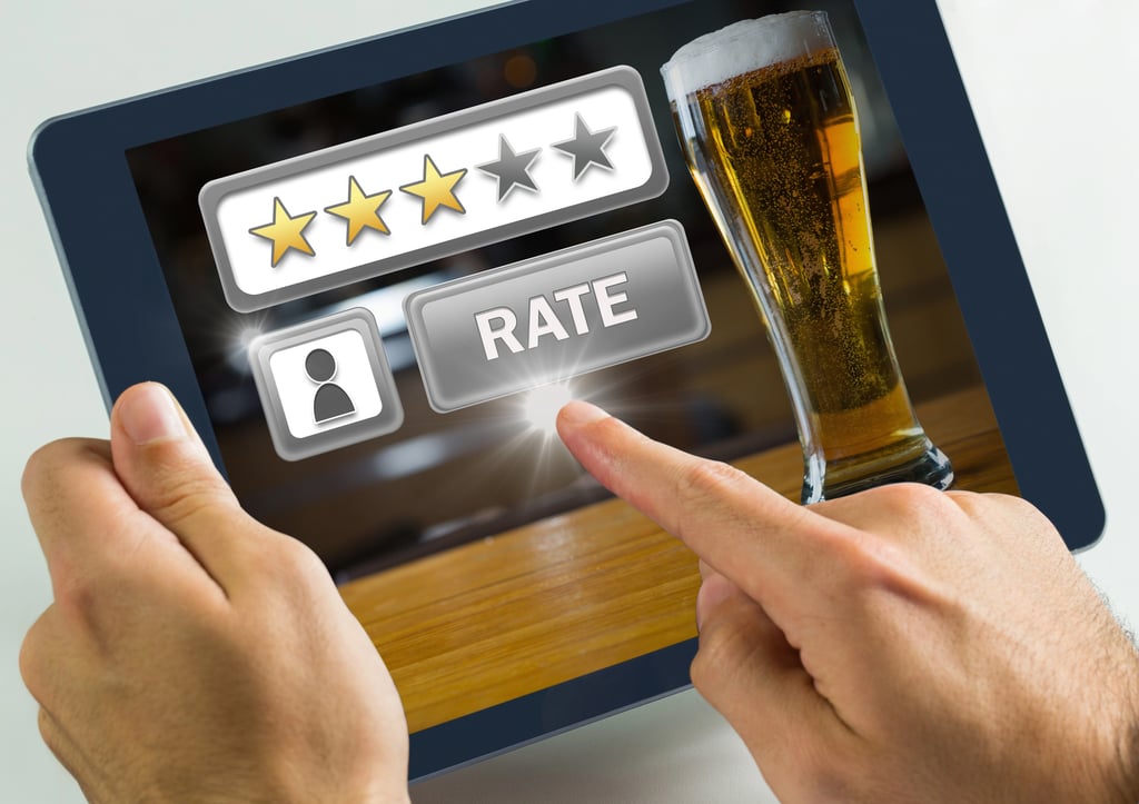 Someone using an app to rate beer online.