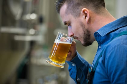 Brewer using sensory analysis to understand his beer.