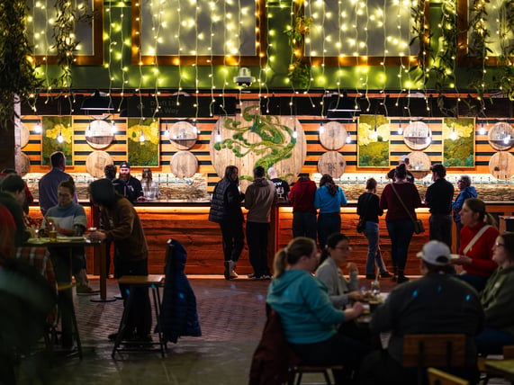 Tree House Brewing Taproom with people ordering beer at the bar.
