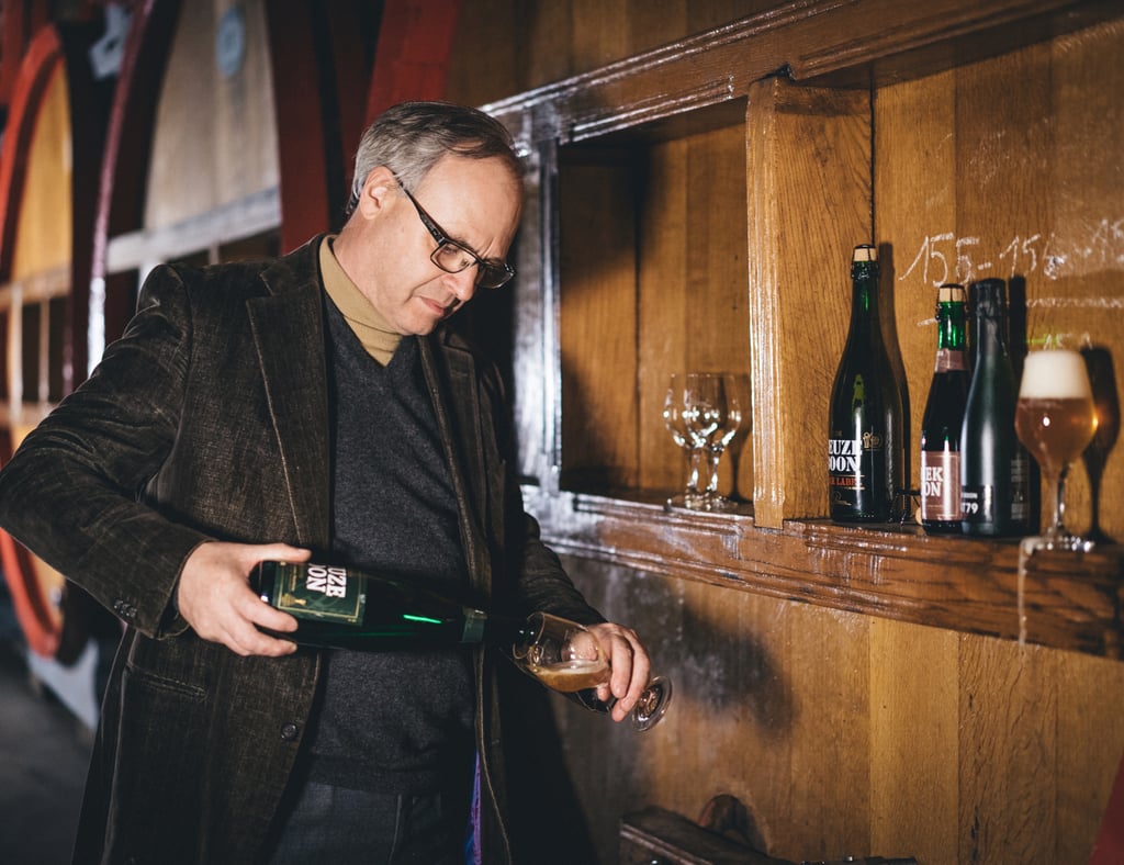 Frank Boon pouring a bottle of Oude Geuze Boon at the brewery.