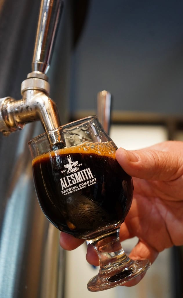 AleSmith tap pouring a Speedway Imperial Stout beer into branded glassware.