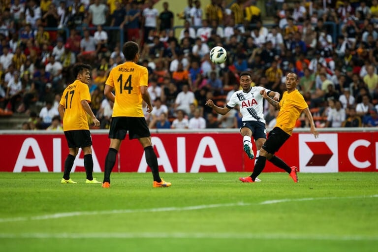Malaysia national football team players challenge for the ball during an international match, representing a key moment from Malaysia's 2023–2026 football cycle.